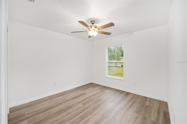 spare room with ceiling fan and light hardwood / wood-style floors