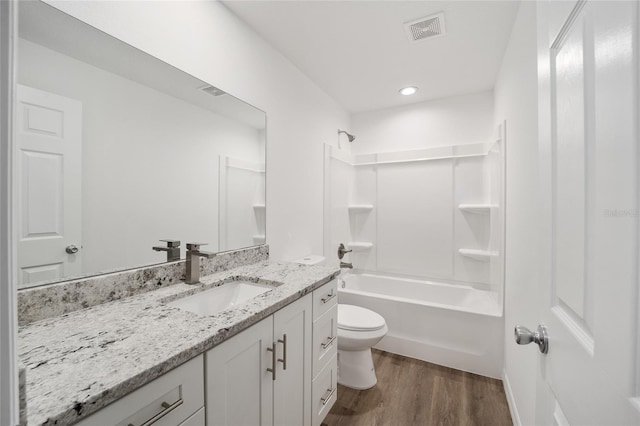 full bathroom featuring toilet, shower / bathtub combination, wood-type flooring, and vanity