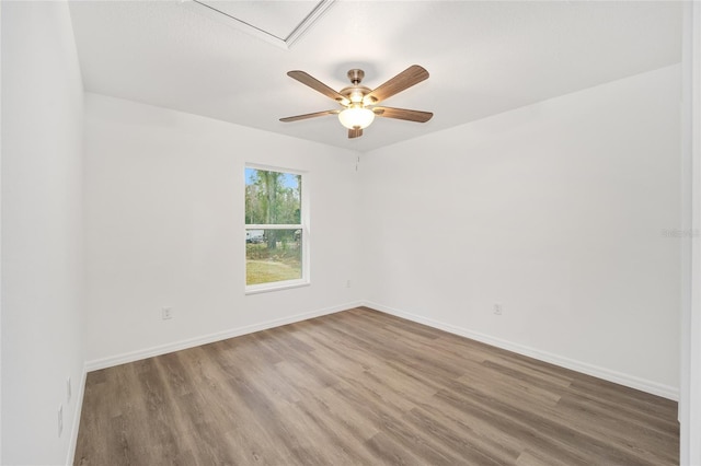 empty room with ceiling fan and wood-type flooring