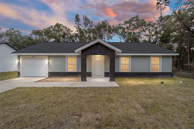 ranch-style house with a garage and a lawn