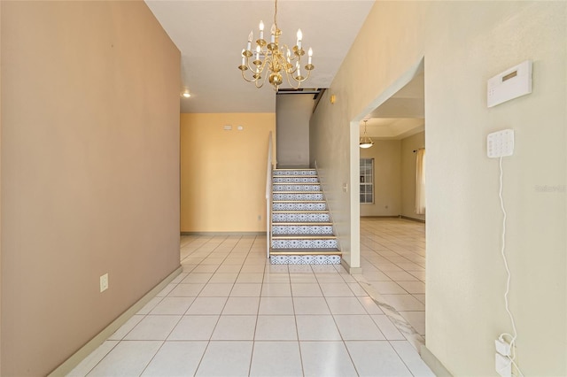 stairs with an inviting chandelier and tile patterned flooring