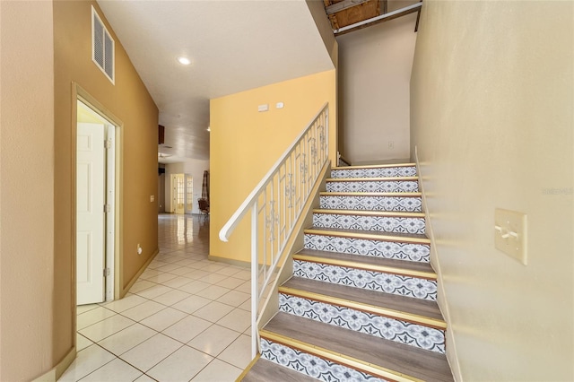 stairs with tile patterned flooring