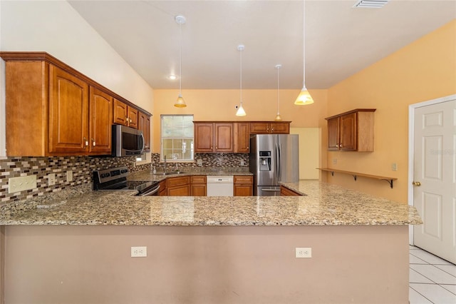 kitchen with appliances with stainless steel finishes, kitchen peninsula, decorative backsplash, and hanging light fixtures