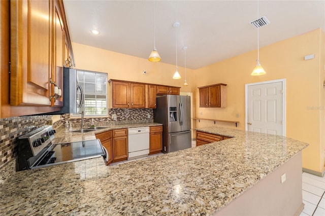 kitchen with appliances with stainless steel finishes, kitchen peninsula, and sink