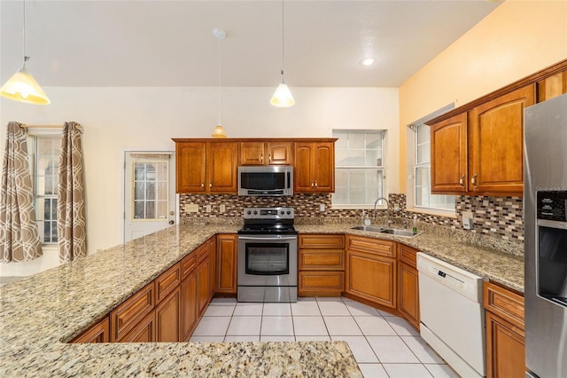 kitchen featuring light tile patterned floors, appliances with stainless steel finishes, backsplash, sink, and decorative light fixtures