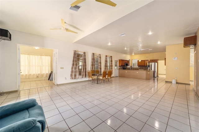 unfurnished living room with ceiling fan and light tile patterned floors