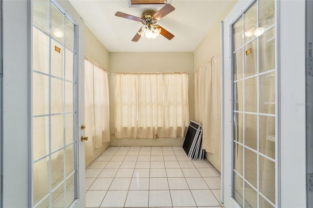 spare room with ceiling fan and light tile patterned flooring