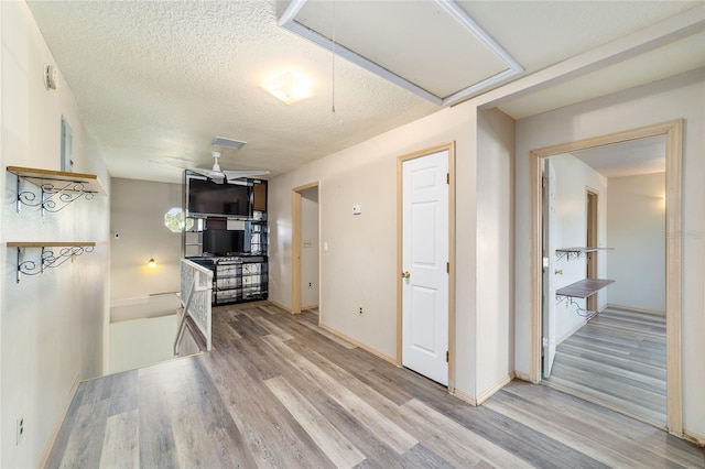 kitchen with a textured ceiling and light wood-type flooring