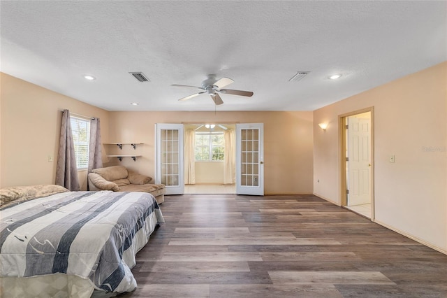 bedroom with french doors, a textured ceiling, ceiling fan, and dark hardwood / wood-style flooring