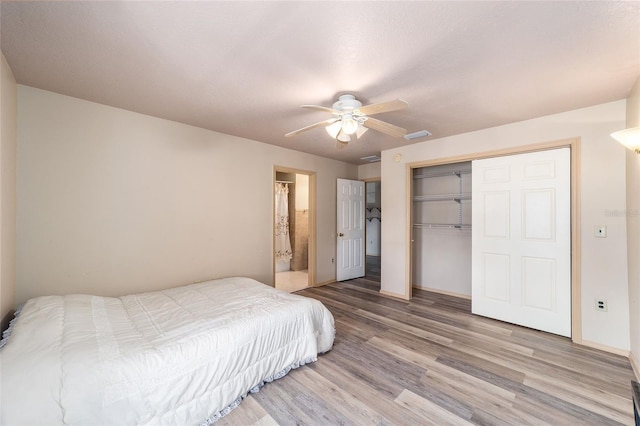 bedroom featuring a closet, light hardwood / wood-style floors, and ceiling fan