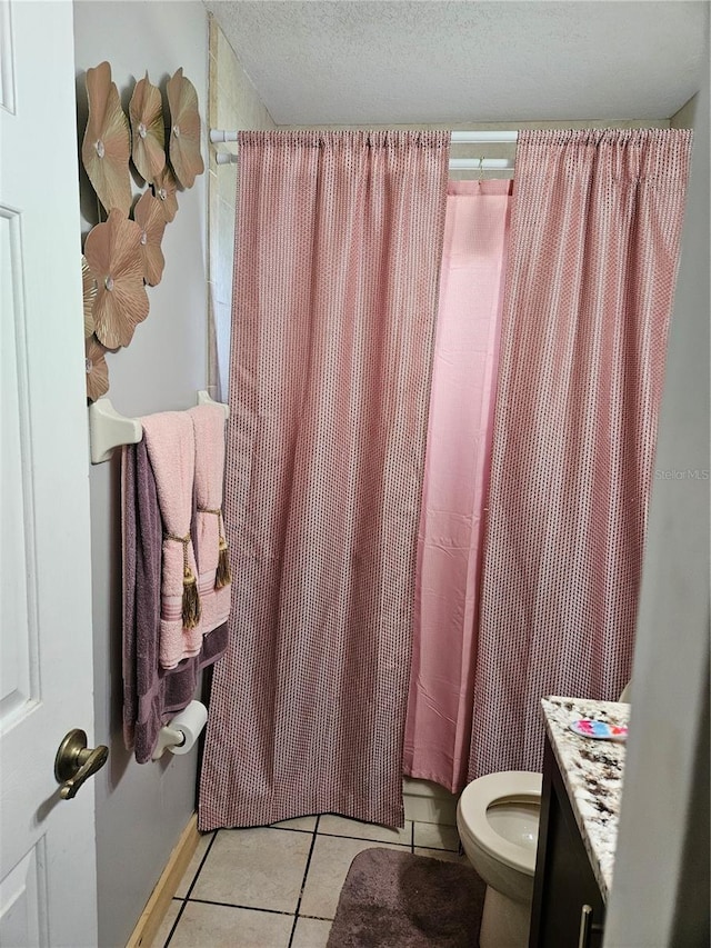 bathroom featuring walk in shower, tile patterned flooring, a textured ceiling, vanity, and toilet