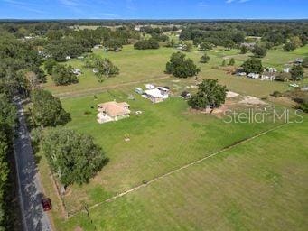 birds eye view of property featuring a rural view