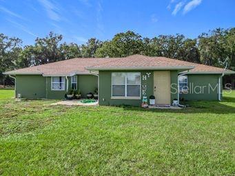 rear view of property featuring a yard