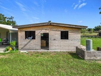 rear view of house with a lawn and a patio