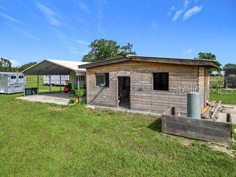 back of house featuring a yard