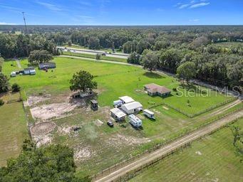 birds eye view of property with a rural view