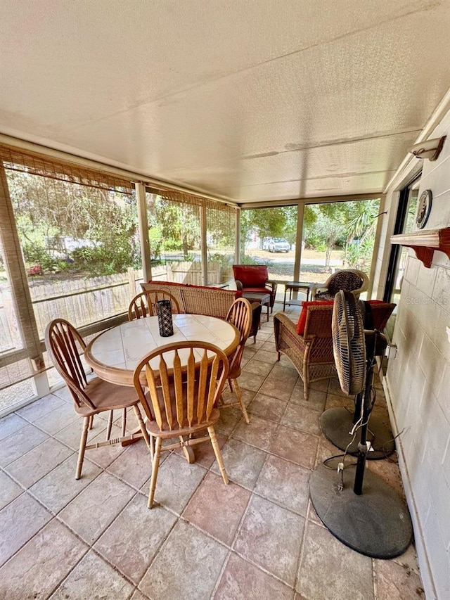 sunroom featuring a fireplace and a wealth of natural light