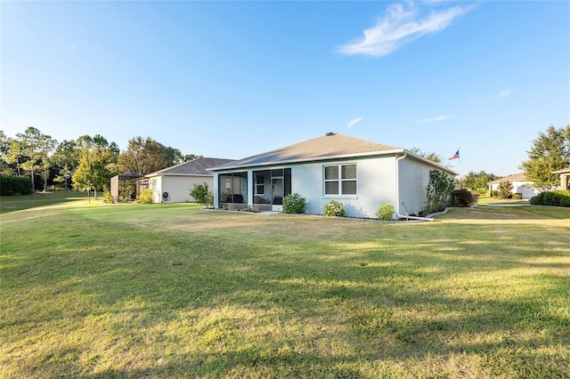 single story home with a sunroom and a front yard