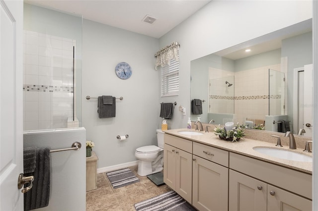 bathroom with toilet, vanity, and walk in shower