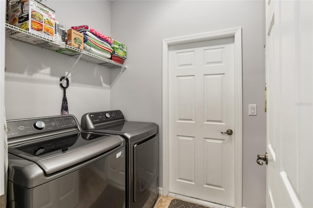 washroom featuring washing machine and clothes dryer and tile patterned floors