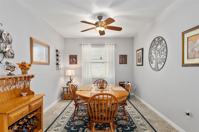 dining area with a textured ceiling and ceiling fan