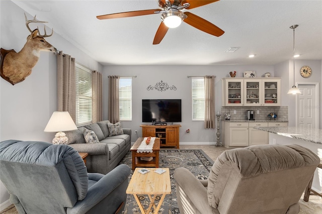 carpeted living room with ceiling fan