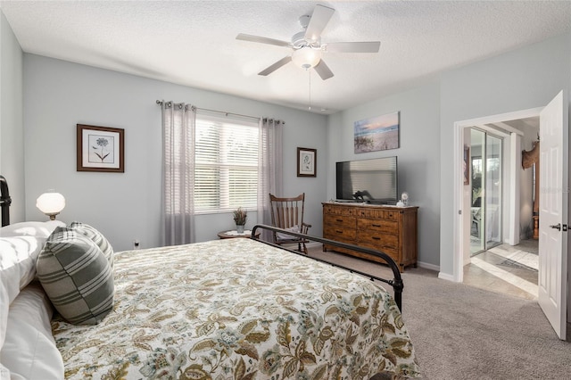 bedroom featuring ceiling fan, light colored carpet, and a textured ceiling