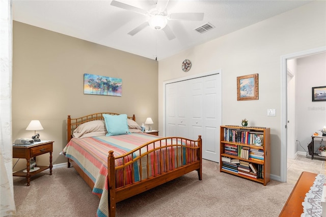 carpeted bedroom featuring ceiling fan and a closet