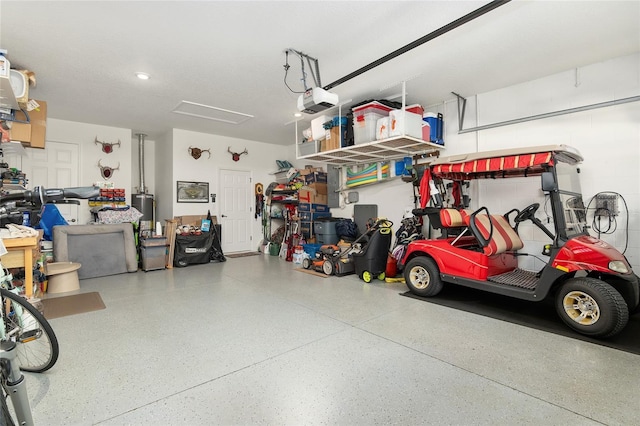 garage featuring gas water heater and a garage door opener