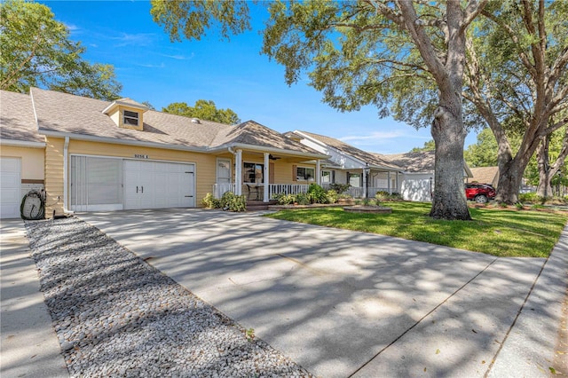 ranch-style home featuring a front yard, a garage, and a porch