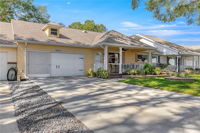 single story home featuring covered porch and a garage