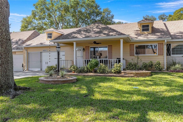 view of front of property featuring a front yard, a garage, and a porch