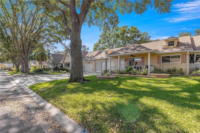 view of front of property featuring a front yard, a porch, and a garage