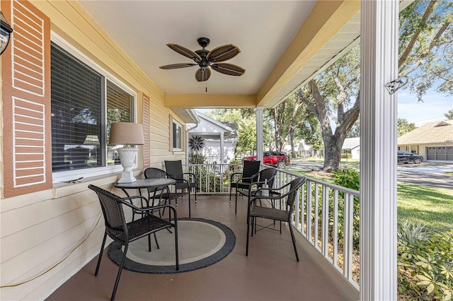 view of patio / terrace with covered porch, a garage, and ceiling fan