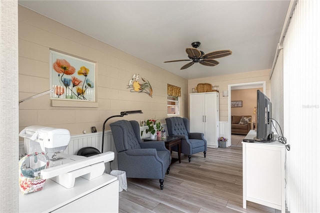 sitting room featuring hardwood / wood-style flooring and ceiling fan