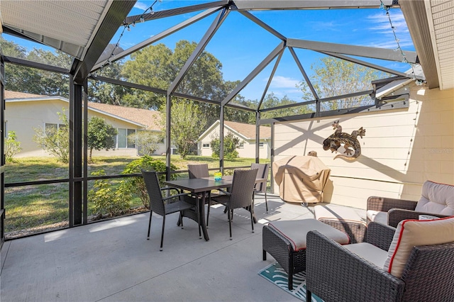 view of patio featuring glass enclosure