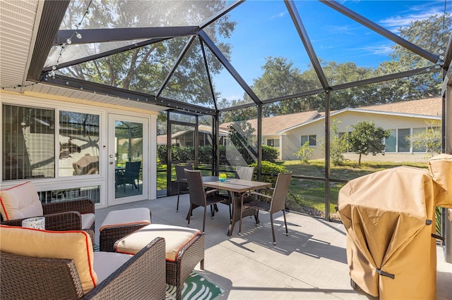 view of patio featuring grilling area and glass enclosure