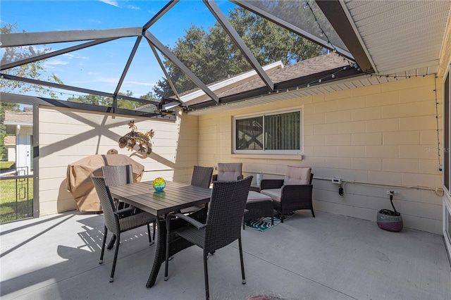 view of patio featuring glass enclosure