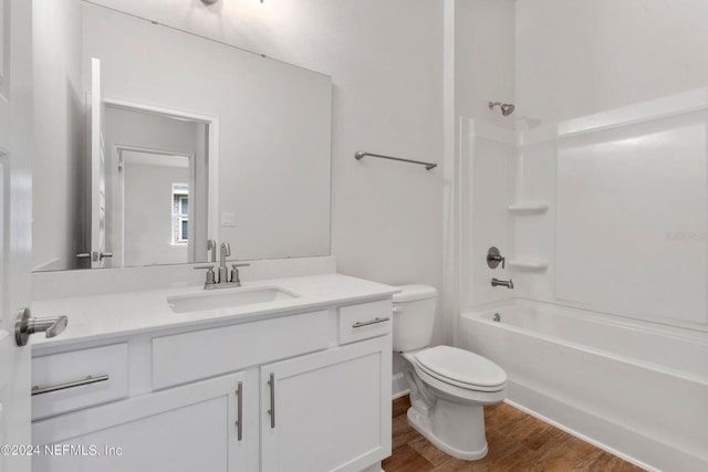 full bathroom featuring vanity, hardwood / wood-style flooring, toilet, and shower / bathtub combination