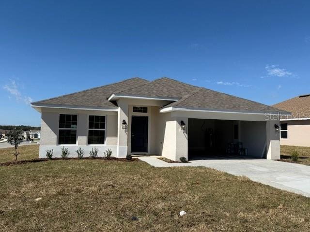 view of front of home with a garage, concrete driveway, a front lawn, and stucco siding