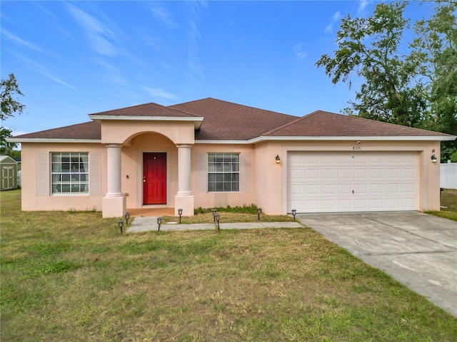 view of front of house with a front lawn and a garage