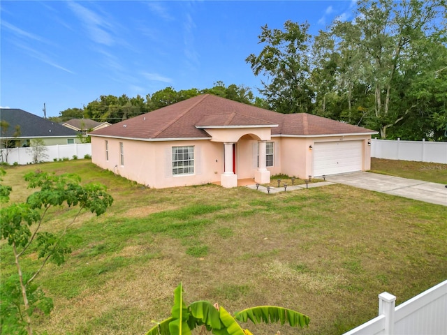 view of front of property with a garage and a front lawn