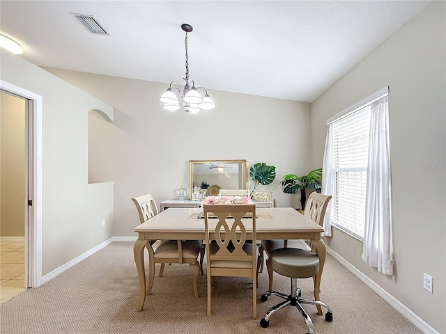 dining room featuring an inviting chandelier and light carpet