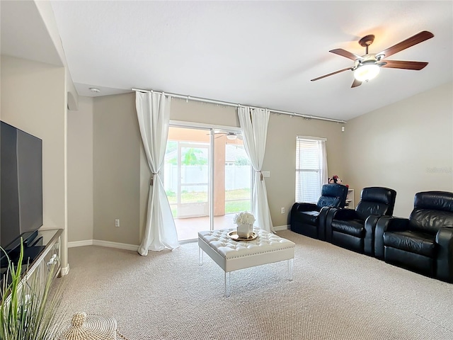 living room with ceiling fan and light colored carpet