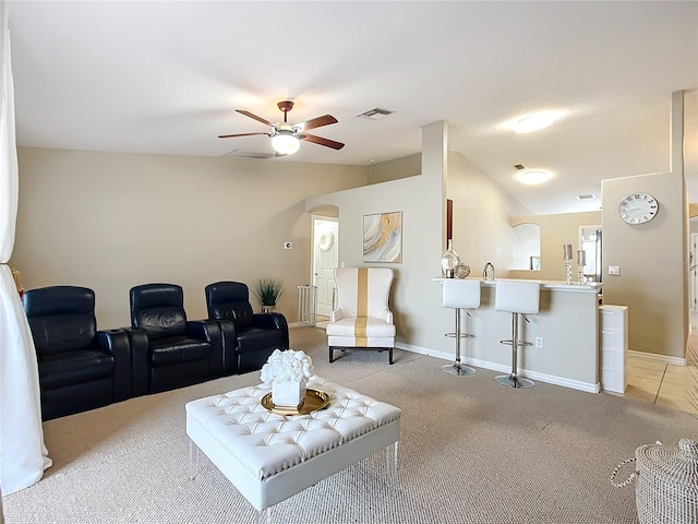 carpeted living room with lofted ceiling, sink, and ceiling fan