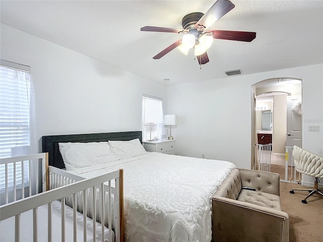 8335 SE 162nd Pl, Summerfield, FL 34491 - bedroom featuring arched walkways, carpet flooring, and ceiling fan