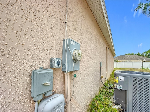 8335 SE 162nd Pl, Summerfield, FL 34491 - exterior view of stucco siding, cooling unit, and electric meter