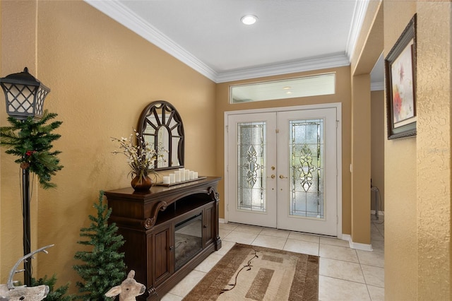 entrance foyer featuring french doors, ornamental molding, and light tile patterned flooring