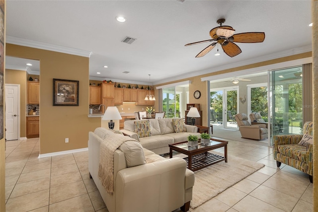 living room with ceiling fan, ornamental molding, and light tile patterned floors