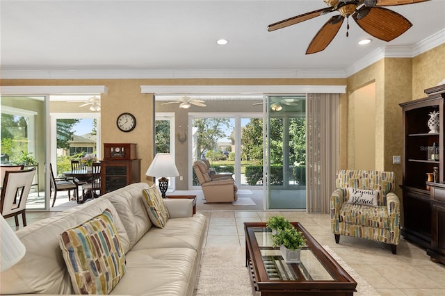 tiled living room with ornamental molding and ceiling fan